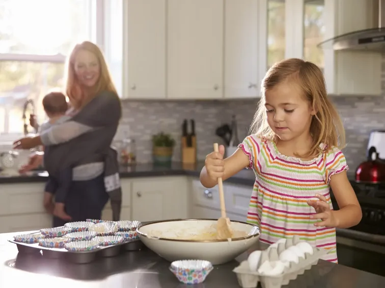 Happy family baking together in a modern kitchen, highlighting a home for sale in Boise.